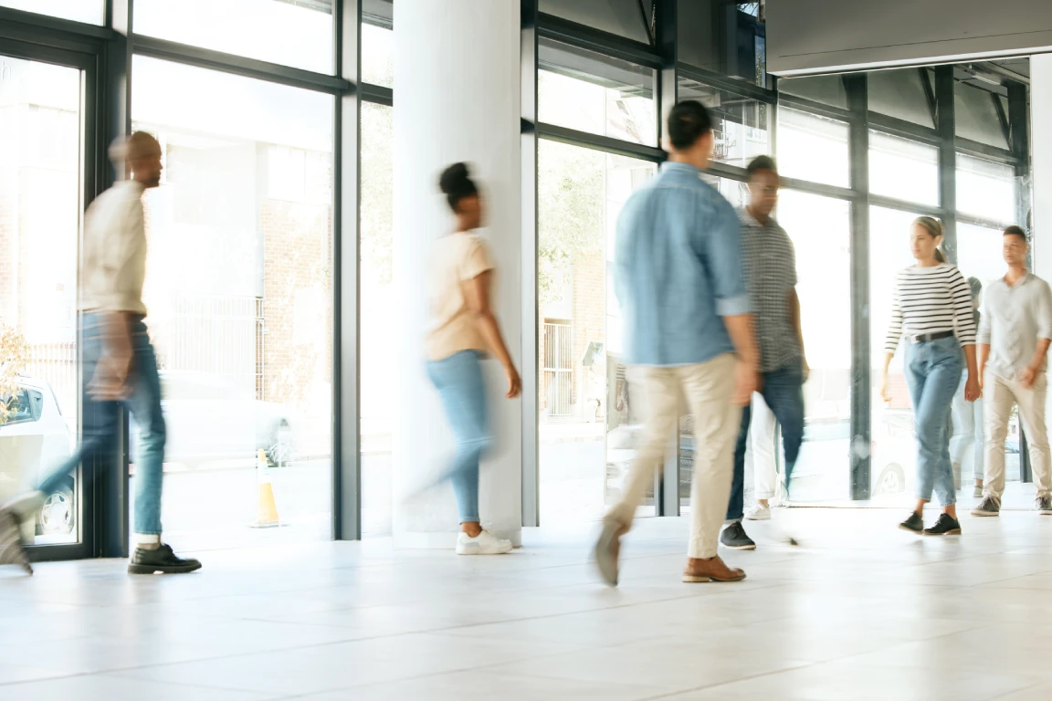 business people in busy office walking fast