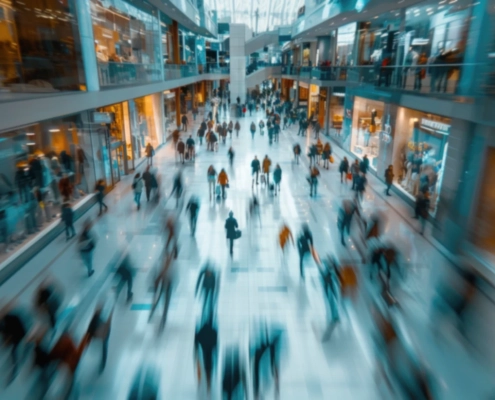 Blurred motion of shoppers moving through a busy multi-level shopping centre