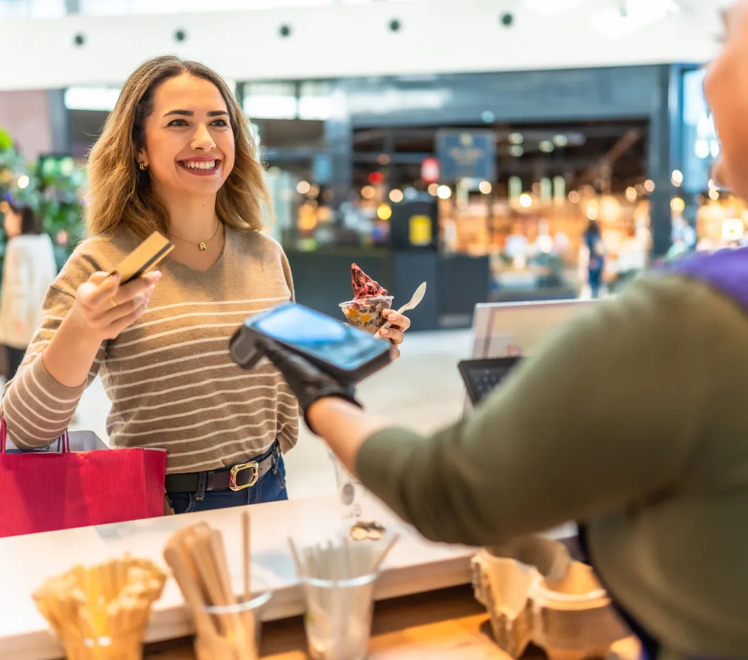 woman-buys-dessert woman buys frozen dessert in a shopping mall
